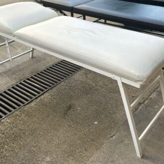 Stationary massage table with folding leg